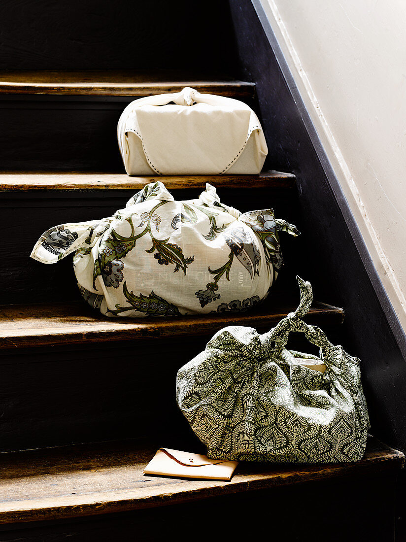 Three fabric bags on treads of old staircase