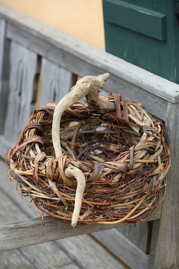 Roughly woven basket made from wicker and gnarled branch
