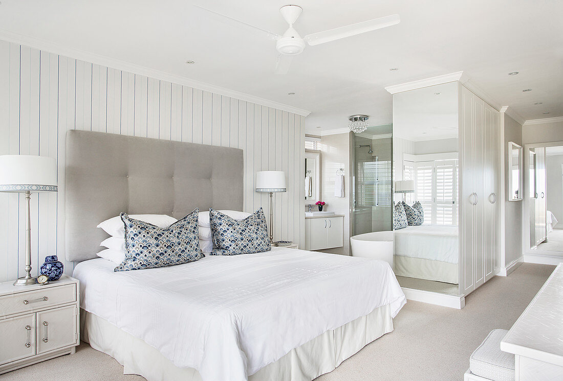 Large white bedroom with ensuite bathroom