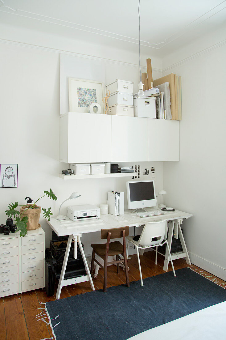 Weißer Schreibtisch, weißer Hängeschrank und Schubladencontainer in Zimmerecke
