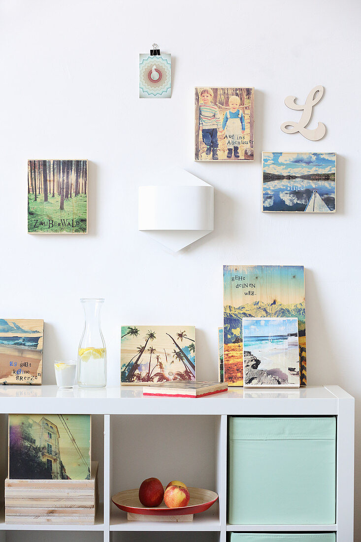 Photos printed on wooden blocks on wall