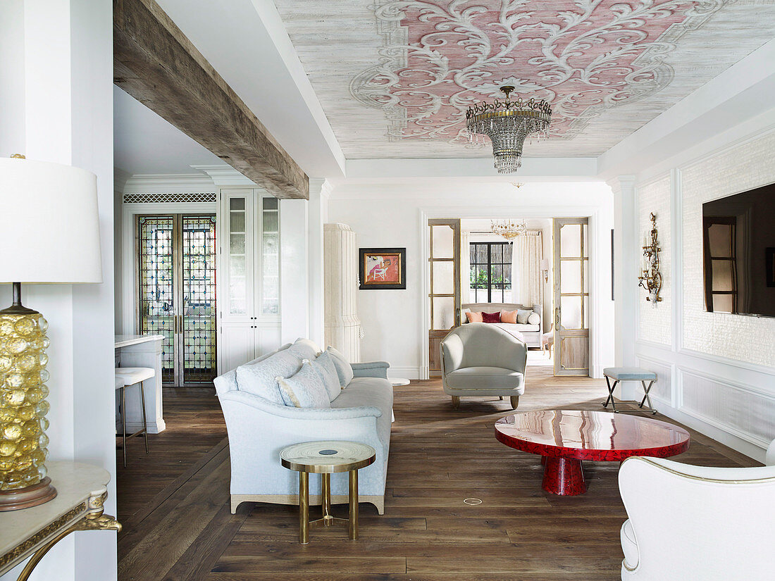 Lounge with elegant upholstered furniture and red coffee table
