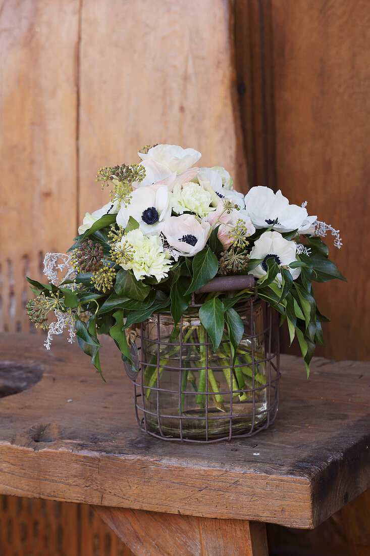 Bouquet of anemones, carnations, ivy leaves and ivy berries