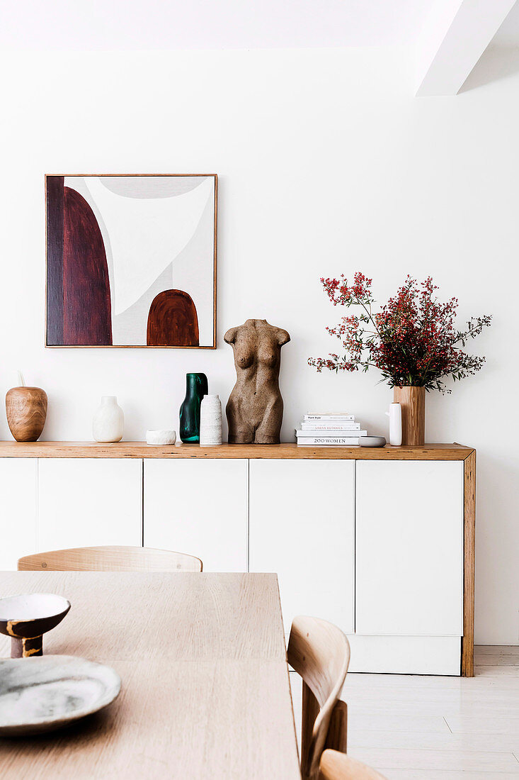 Modern sideboard with sculpture and vases in the dining room
