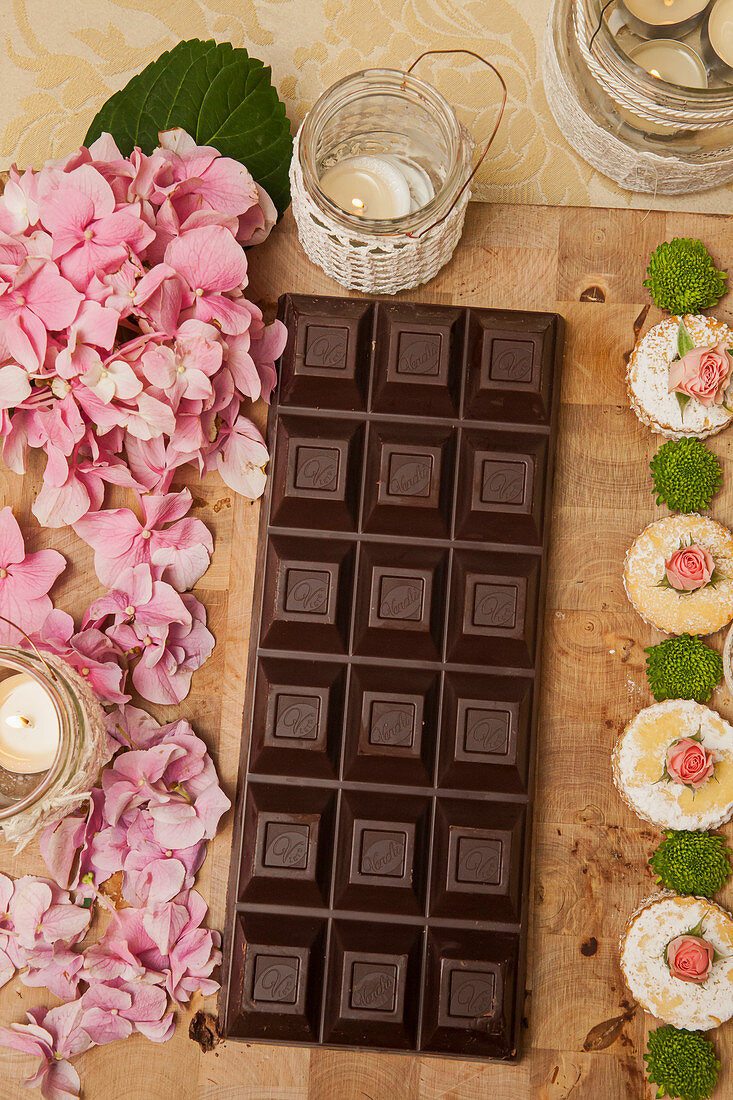 Pink hydrangeas, dark chocolate and cookies decorated with roses