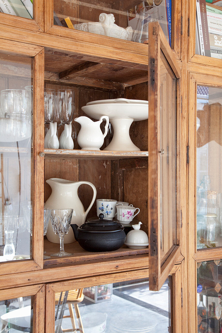 Various crockery in old glass-fronted cabinet