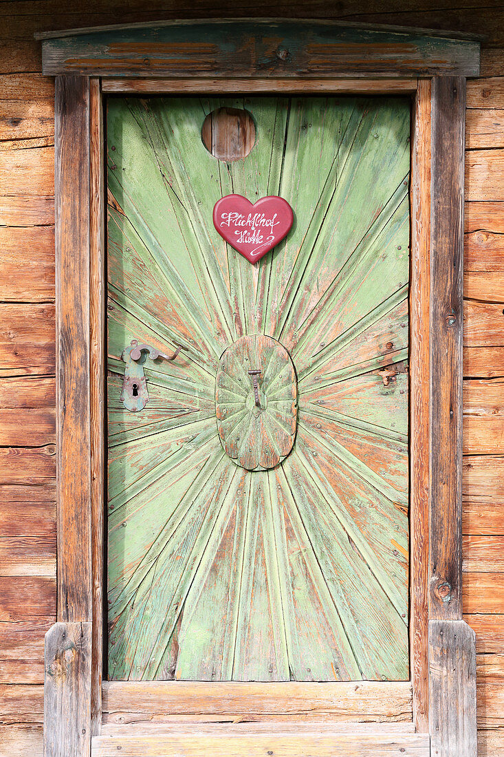 Love-heart sign on rustic wooden door