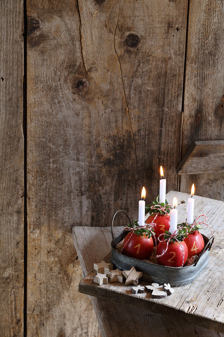 Four apples used as Advent candle holders
