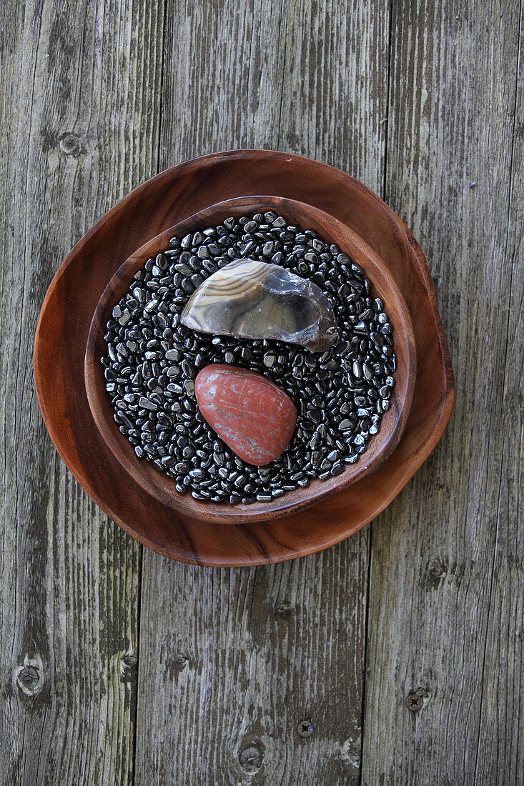 Flint and granite pebbles on haematite gravel in bowl