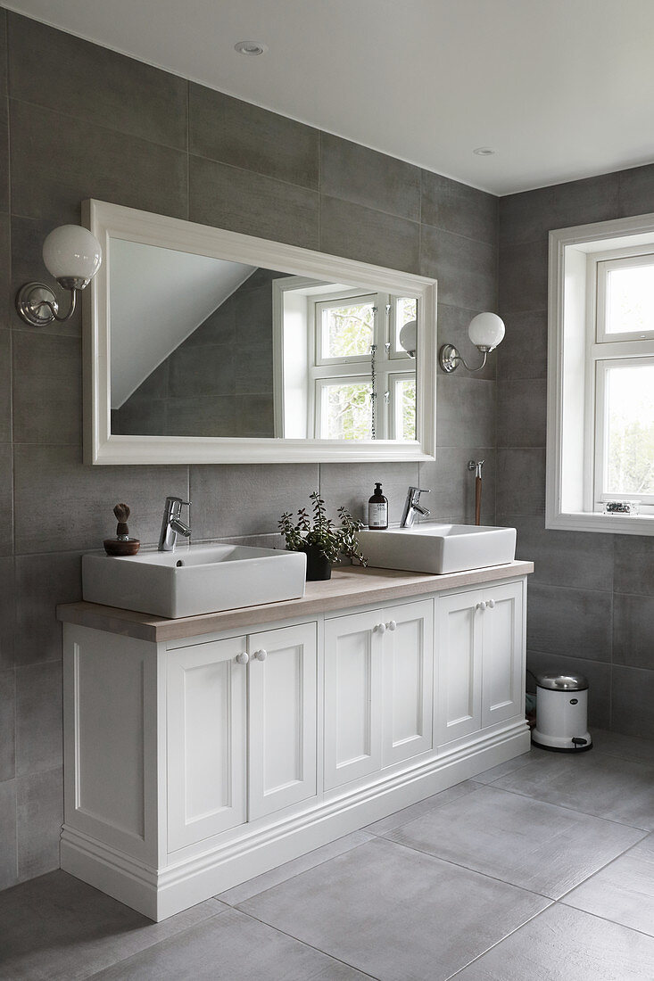 Classic bathroom in grey and white with twin sinks on washstand