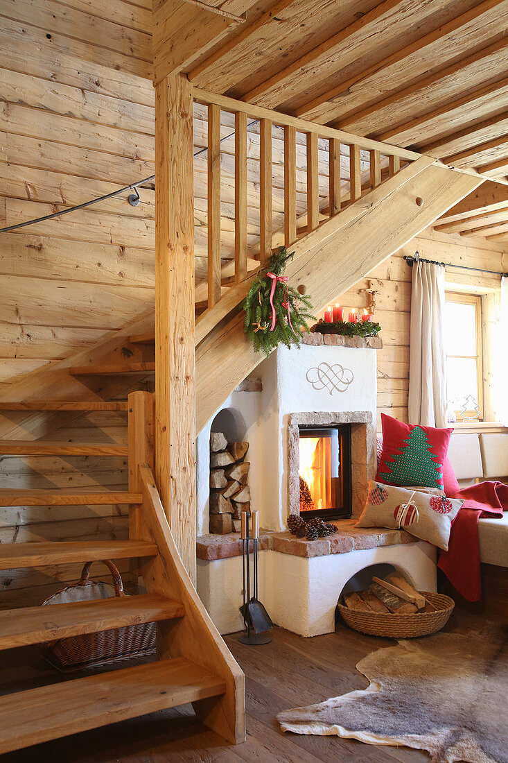 Wooden staircase next to wood-burning stove in log cabin