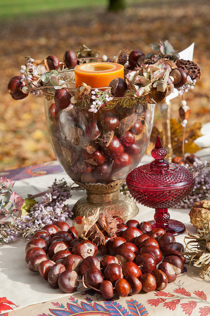 Handmade arrangement of horse chestnuts on table