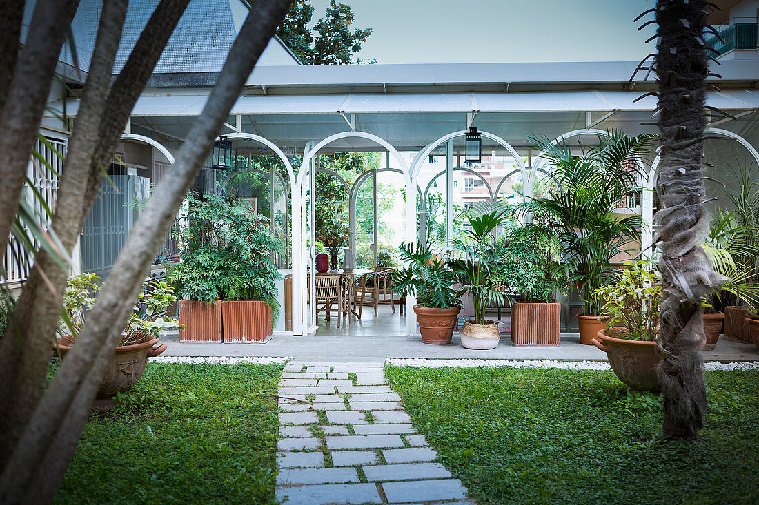 Conservatory with arched windows in Mediterranean garden