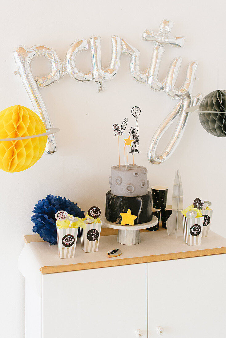 Sideboard decorated with space-themed birthday party