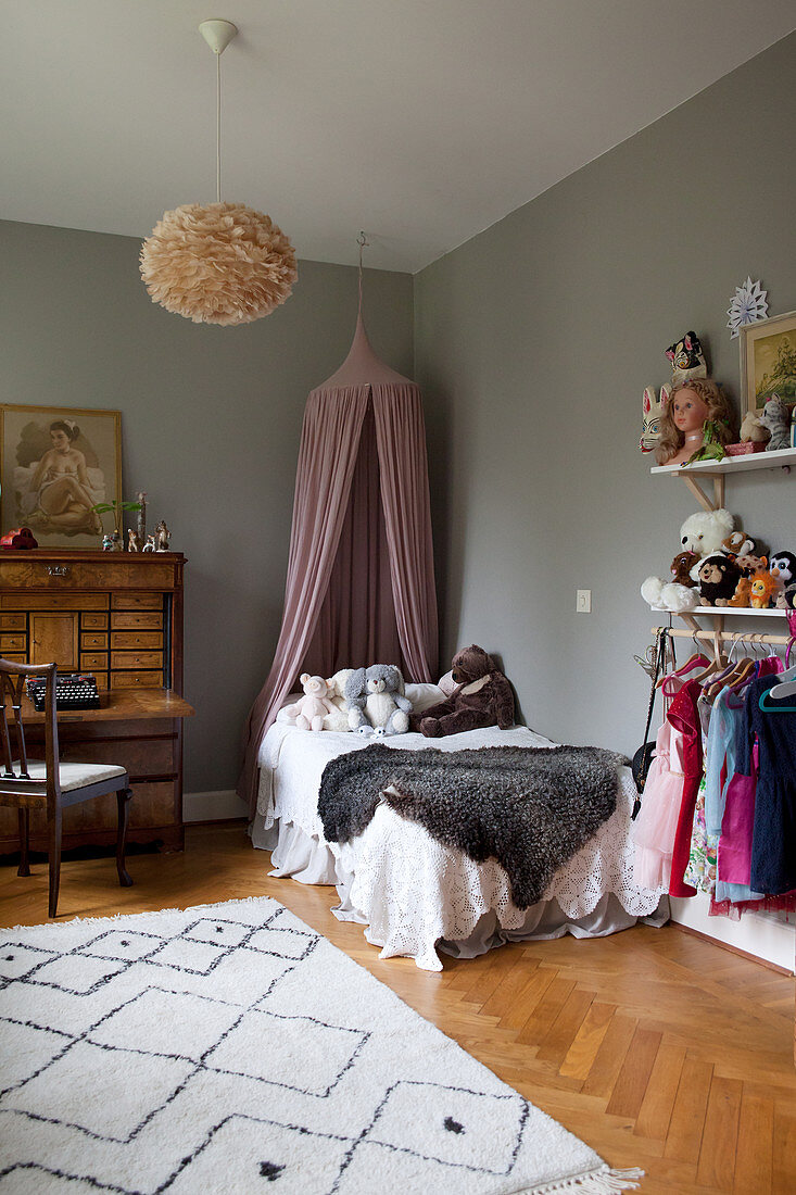 Antique bureau and grey walls in child's bedroom