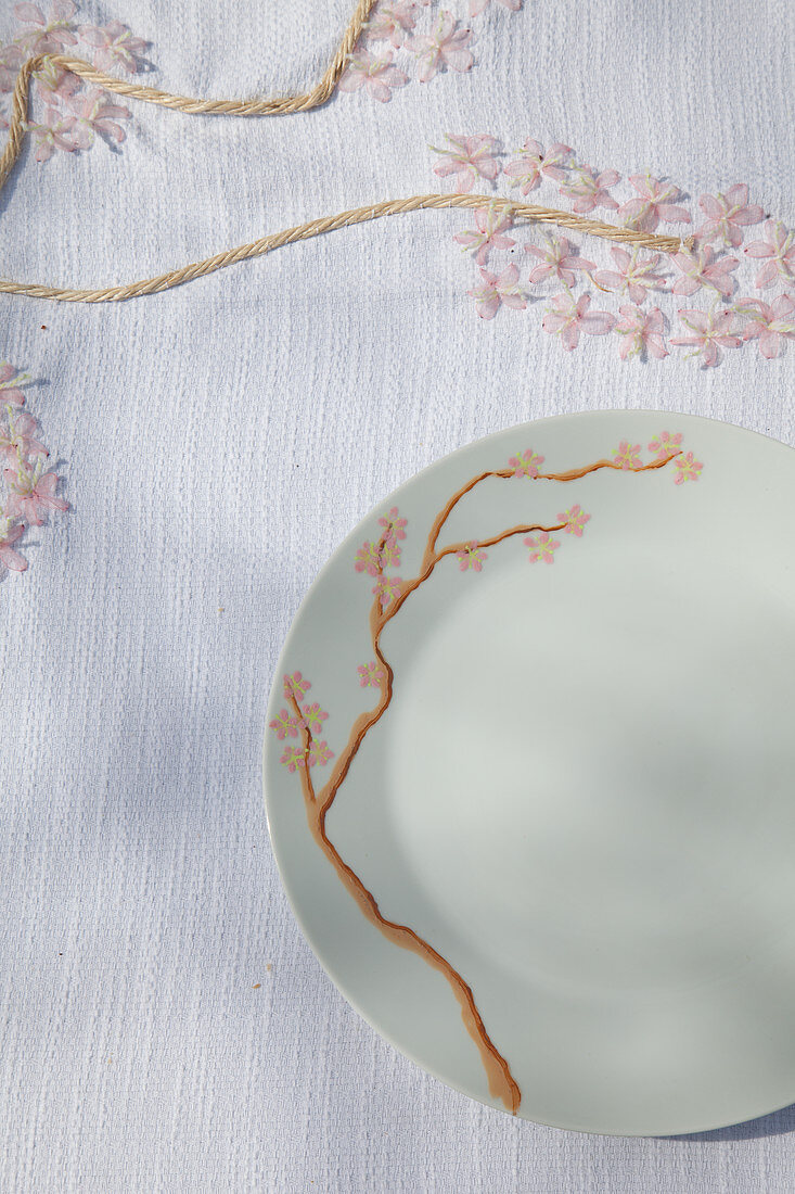 Crockery and tablecloth with handmade cherry blossom patterns