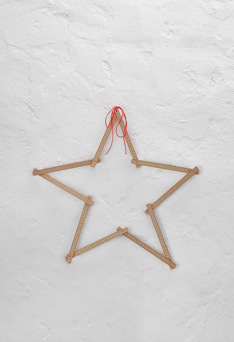 Star made from folding rule on white wall