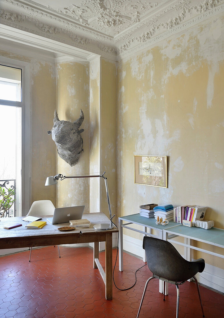 Desk in Mediterranean interior with distressed walls