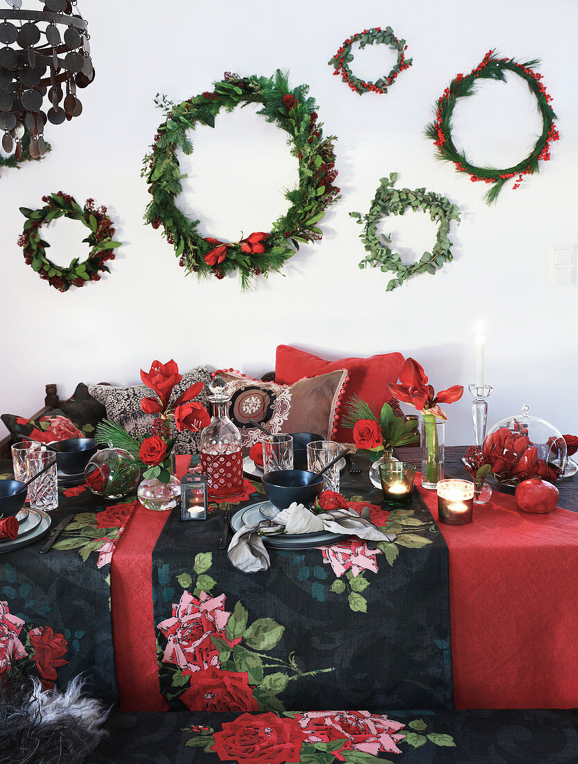 Wreaths above table festively set in red and black
