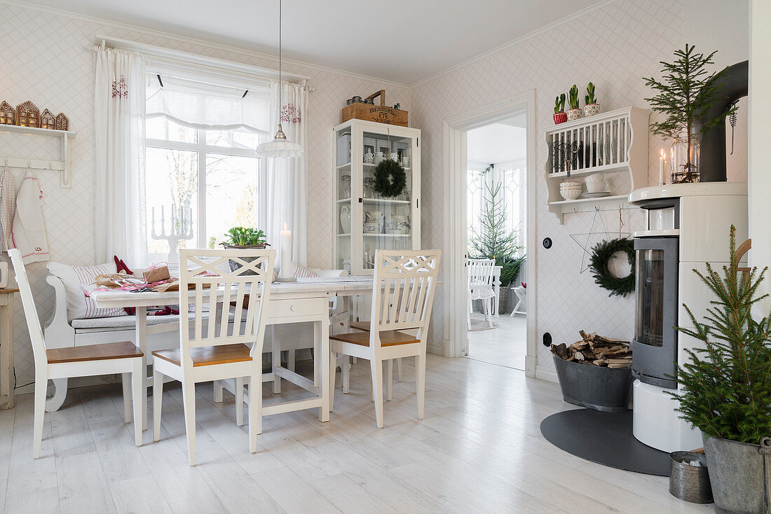 Tisch mit Stühlen in weihnachtlich dekorierter Wohnküche