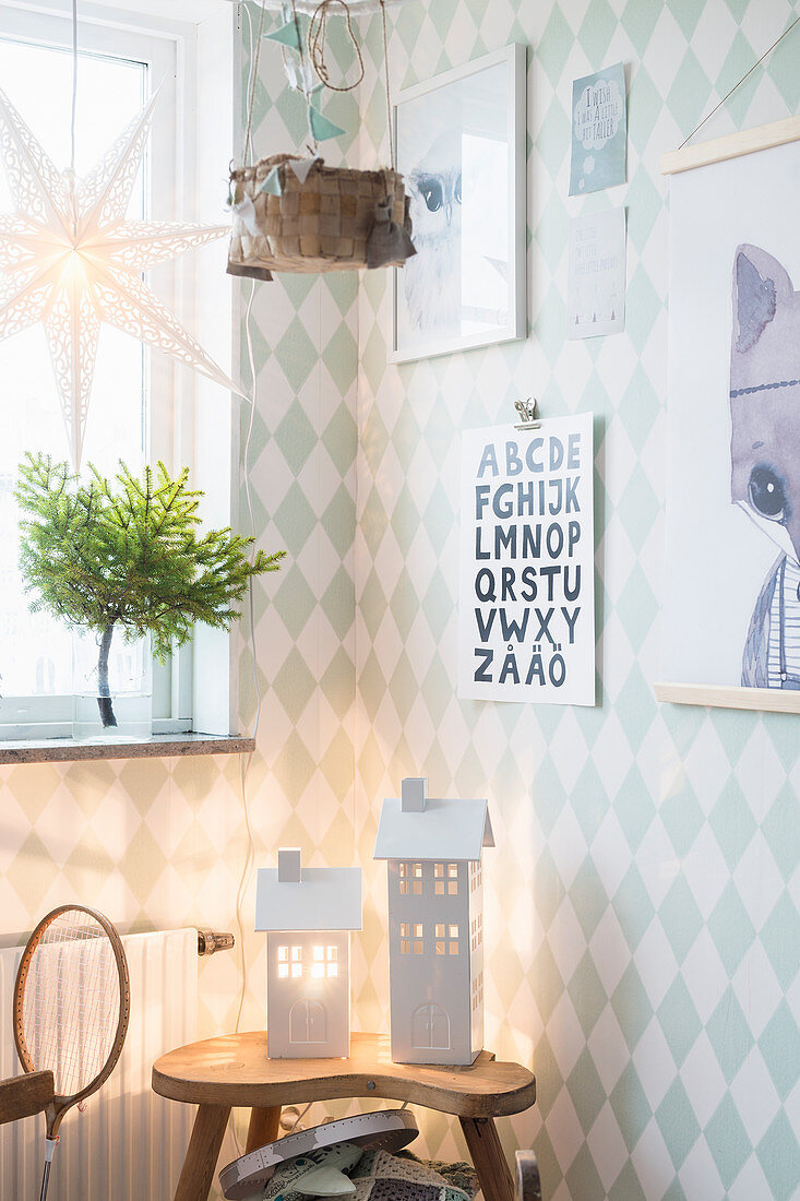 Two illuminated house-shaped lanterns in child's bedroom