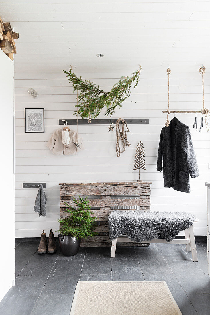 Christmas decorations in rustic foyer in grey and white