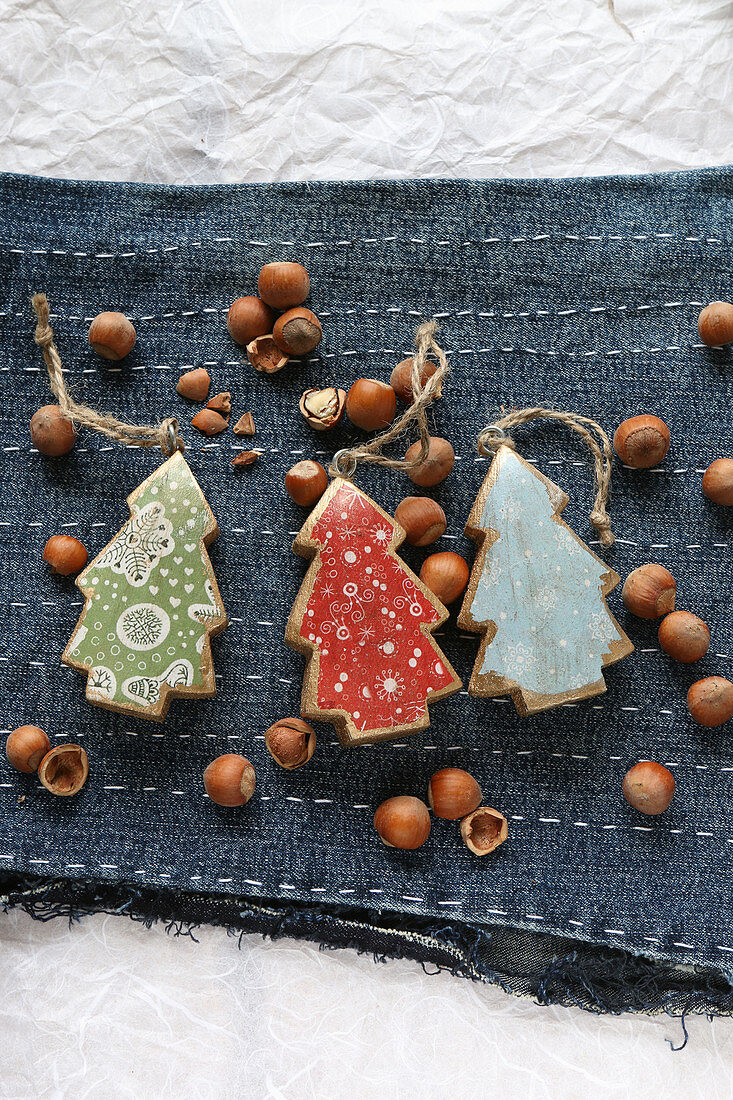 Colourful Christmas tree pendants on embroidered denim