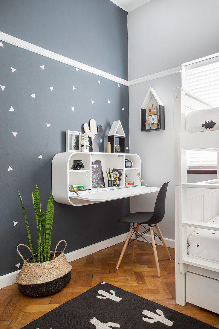 Wandregal mit integriertem Schreibtisch an grauer Wand im Kinderzimmer