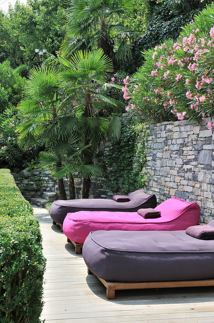 Loungers with pink and purple mattresses on Mediterranean terrace