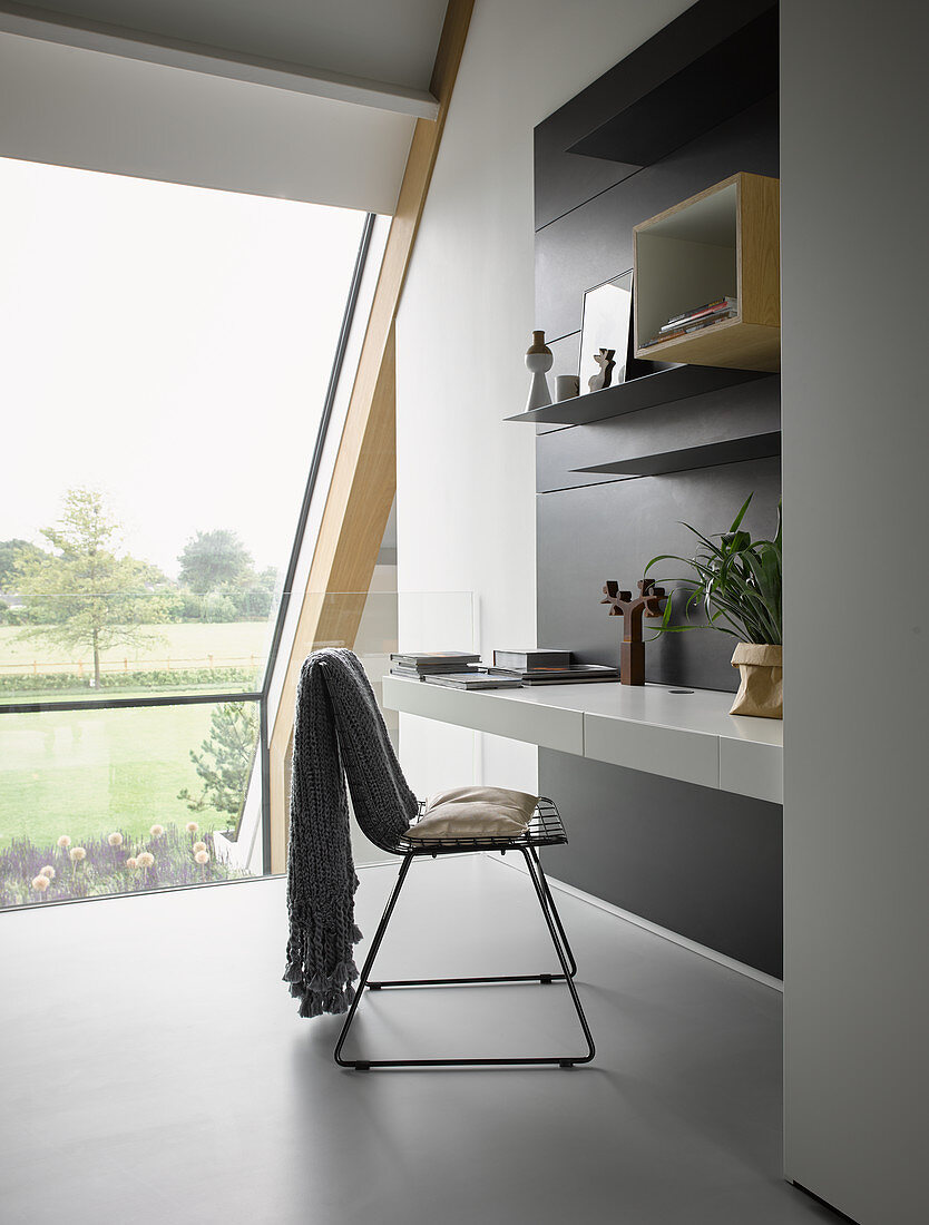 Wall-mounted desk on gallery with glass balustrade