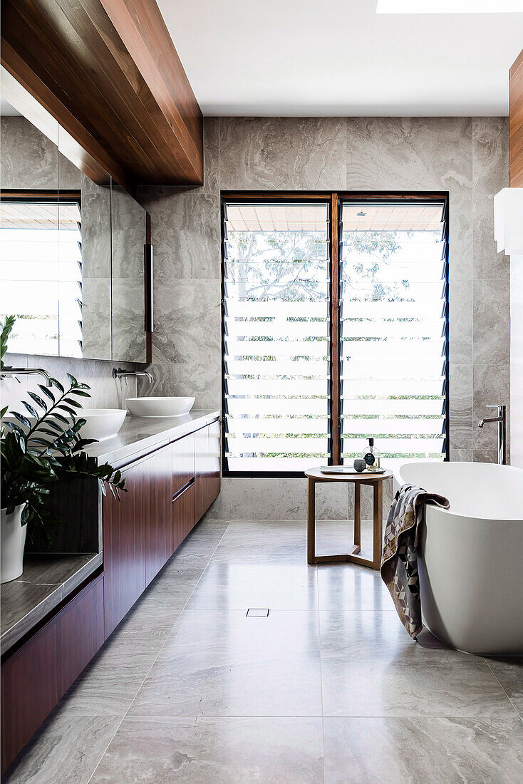 Bespoke vanity with two sinks and free-standing bathtub in the bathroom