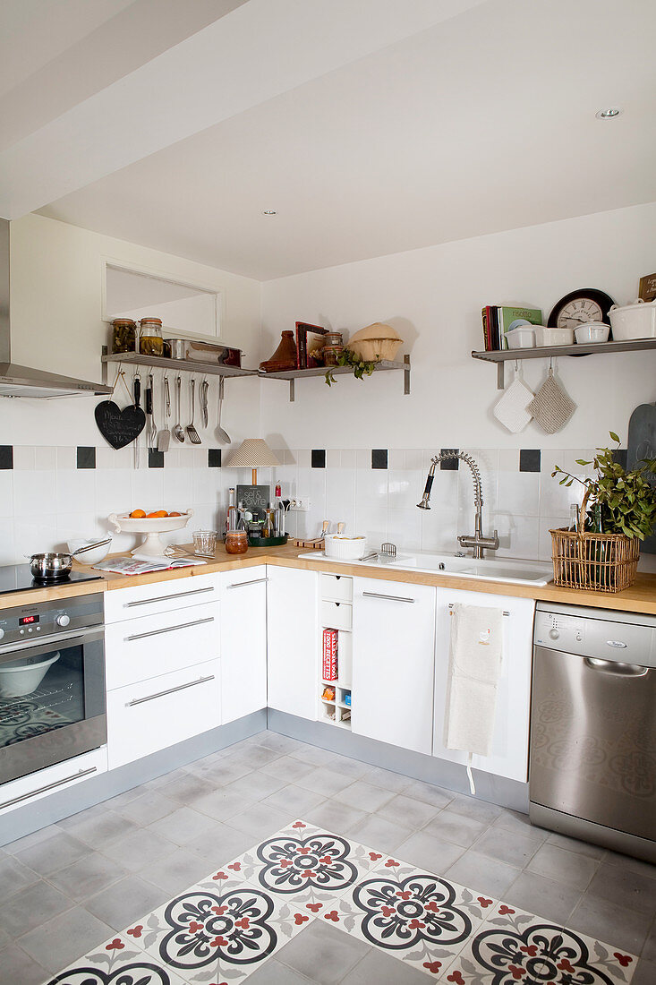 Patterned floor tiles in modern country-house kitchen