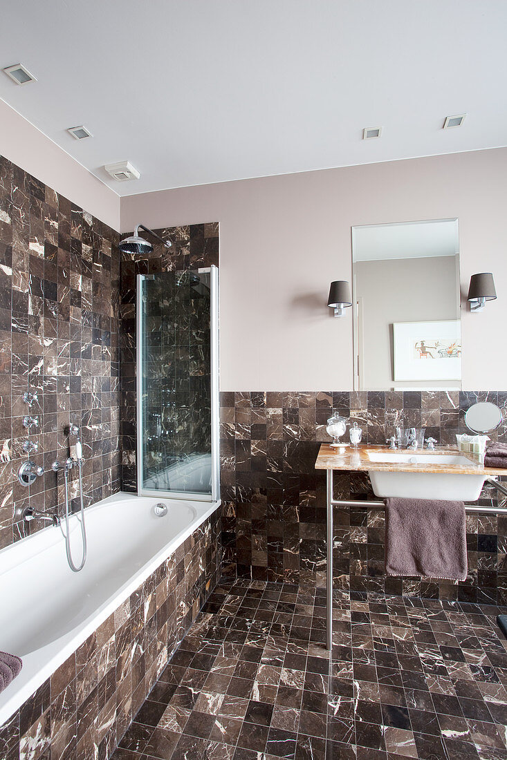 Elegant bathroom with small, dark marble tiles