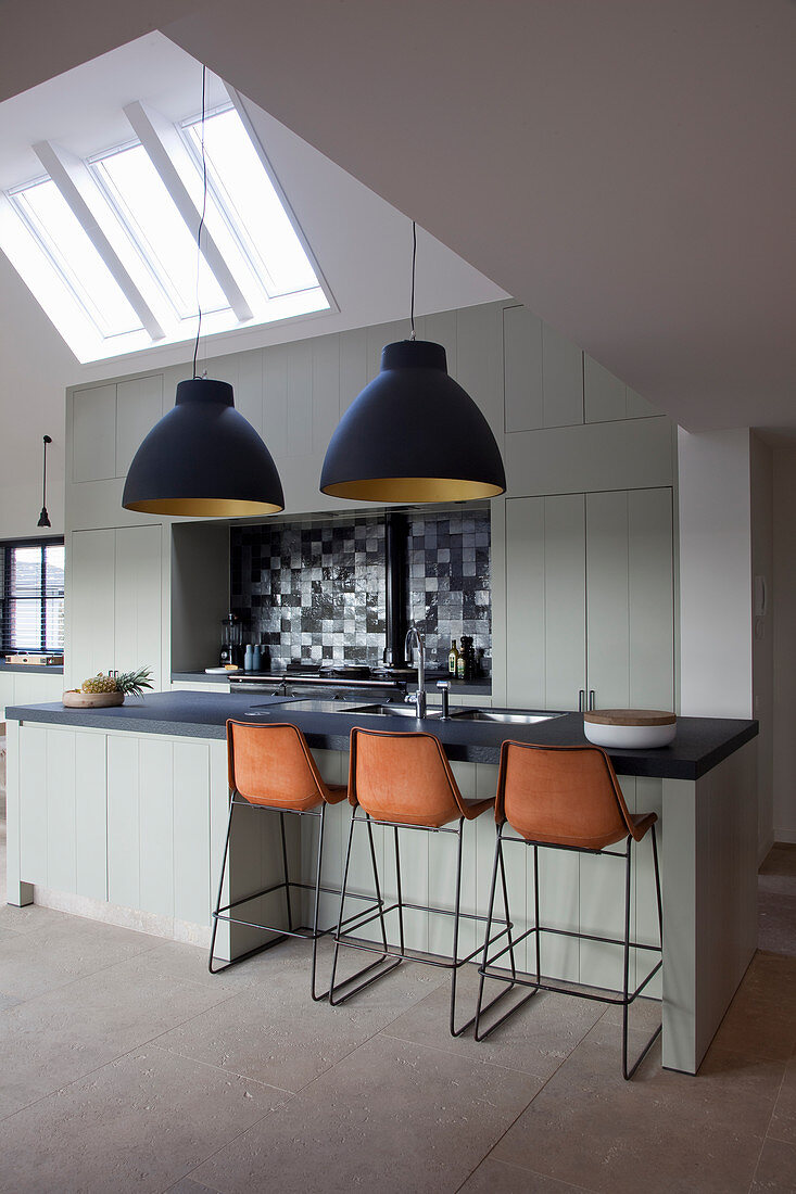 Luxurious, industrial-style kitchen-dining room with gable roof