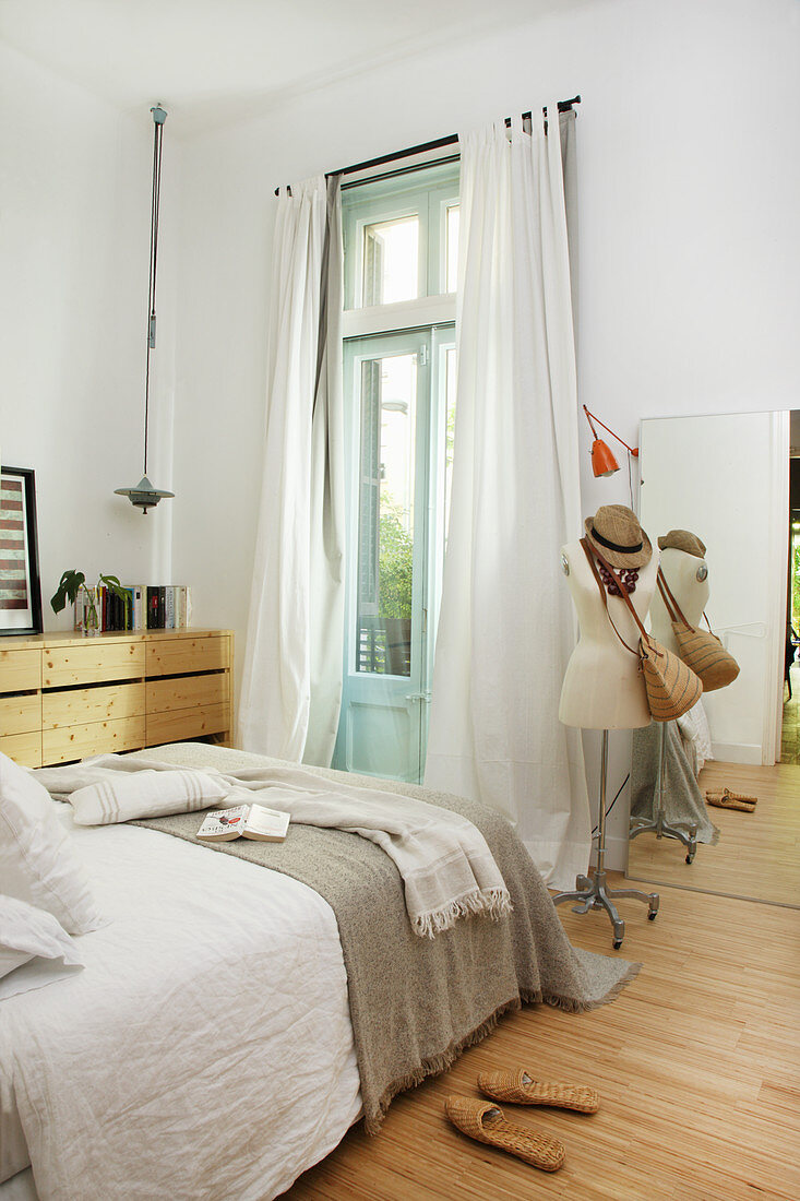 Tailors' dummy in simple bedroom in natural shades