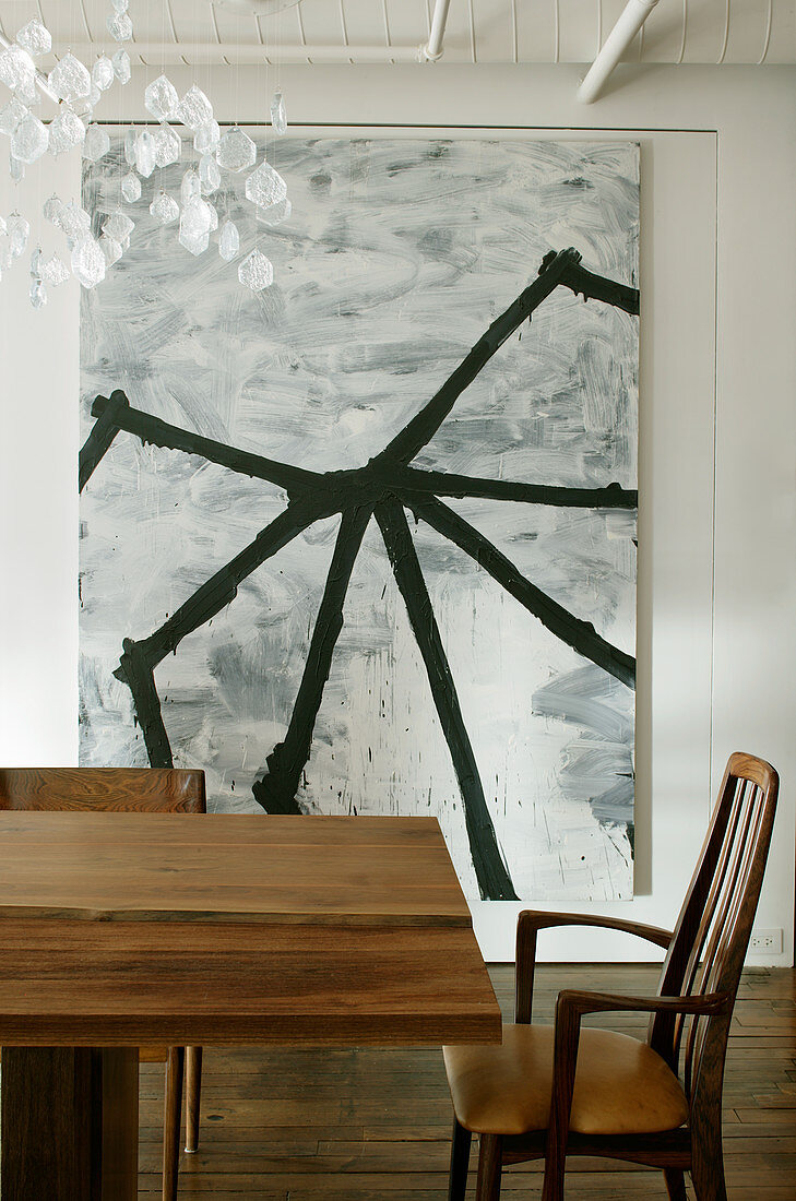 Abstract monochrome painting behind dining table