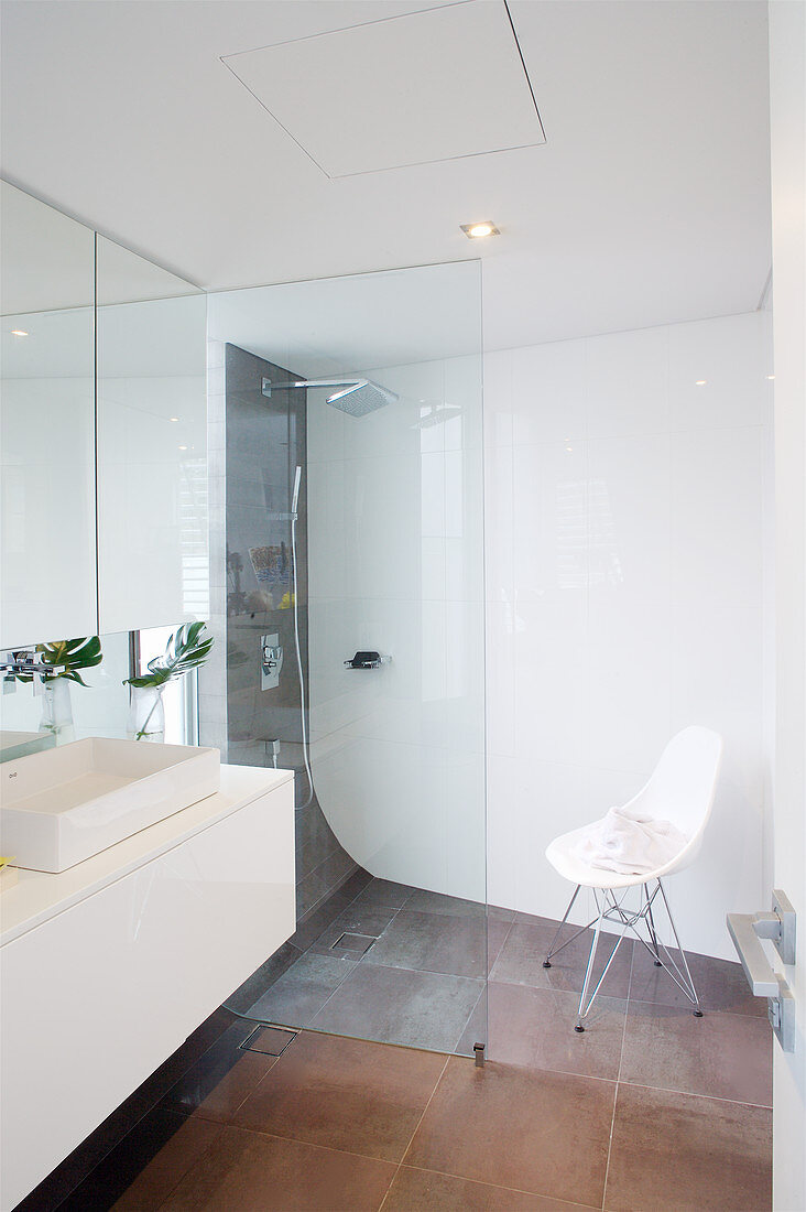 Walk-in shower in modern bathroom with rounded corners