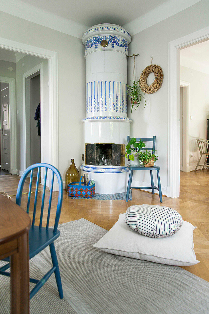 Round Swedish tiled stove in open-plan living room