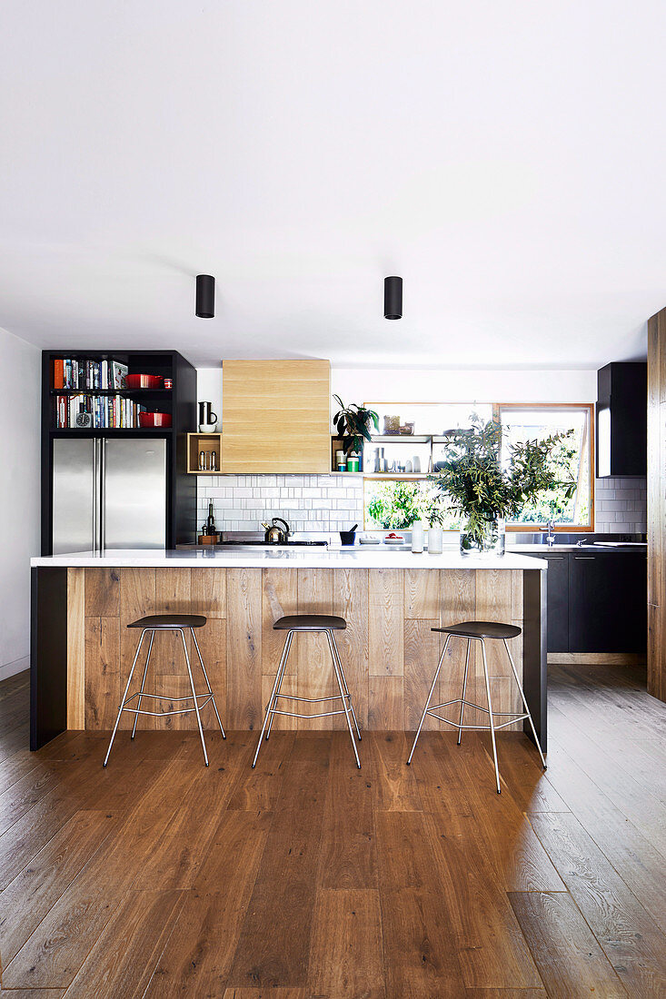 Open kitchen with island and breakfast bar