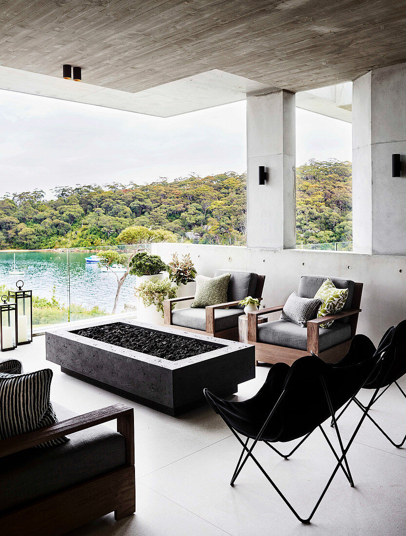 Fire pit and classic seating on terrace with concrete ceiling