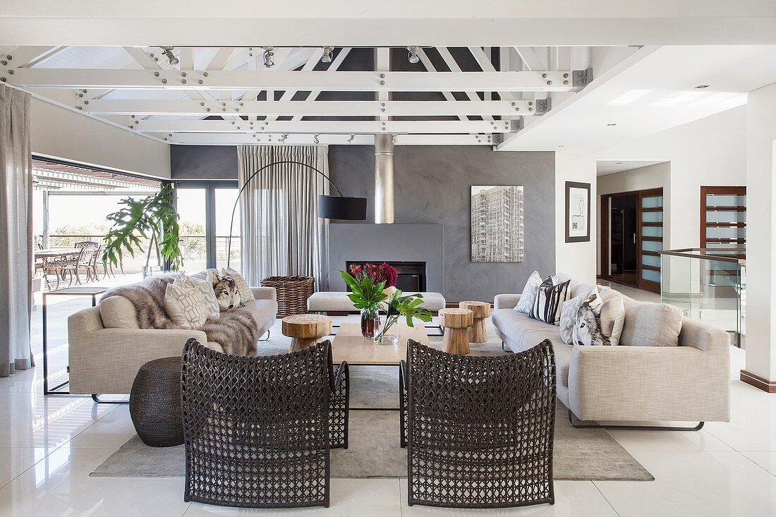 Pale sofa set and black designer chairs in lounge