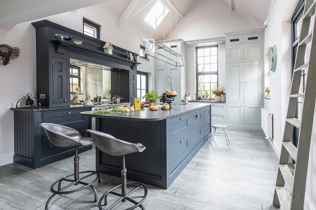 Modern country-house kitchen in shades of grey with open roof structure