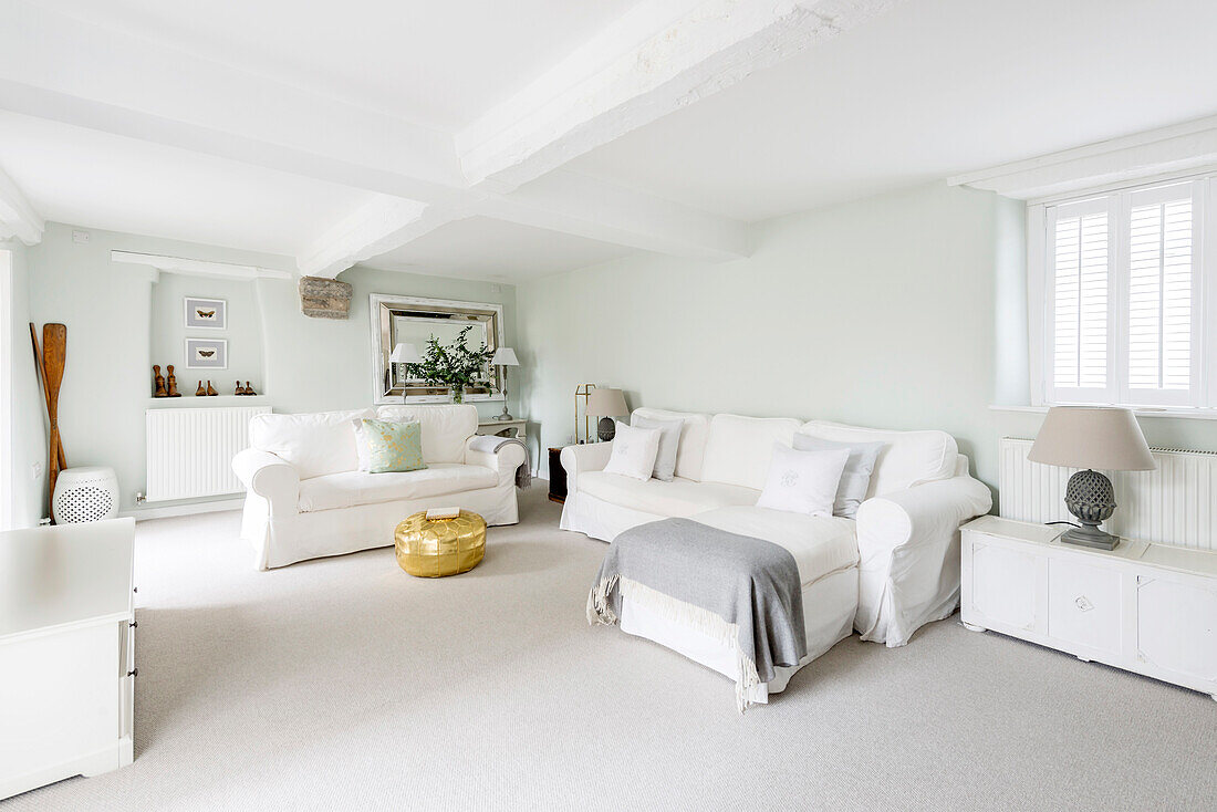 Rustic, white living room with ceiling beams