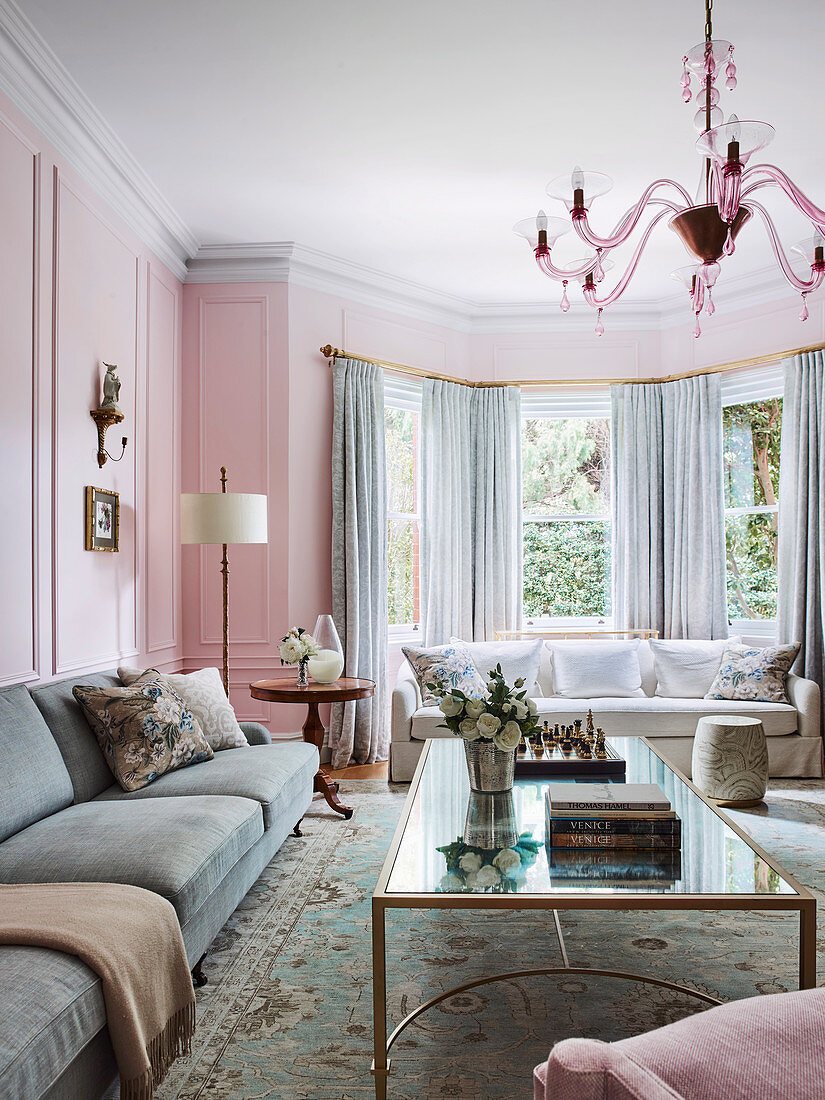 Elegant living room with bay window in shades of pink and gray