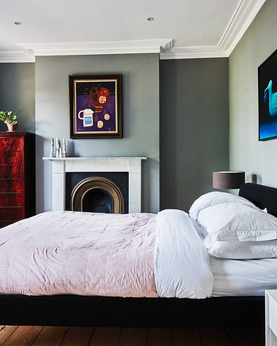 Grey walls, open fireplace and stucco frieze in classic bedroom