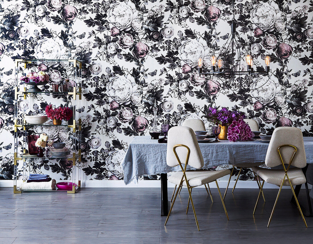 Elegant dining room with opulent floral wallpaper and golden details
