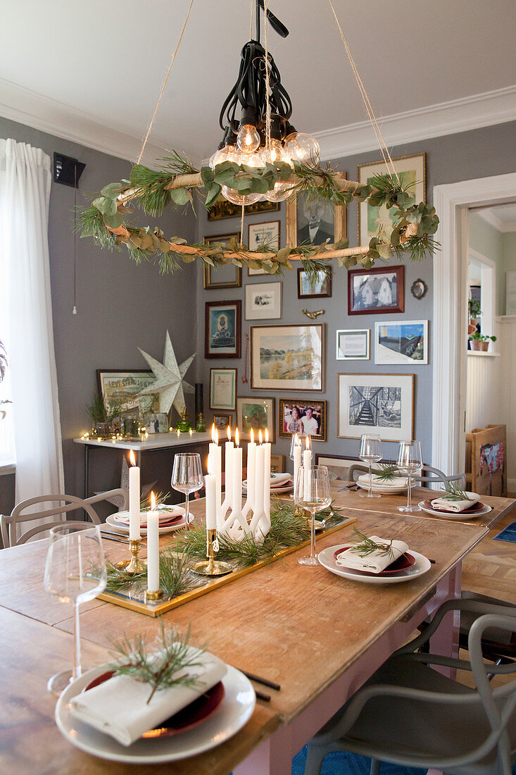 Wreath hung above table set for Christmas in dining room