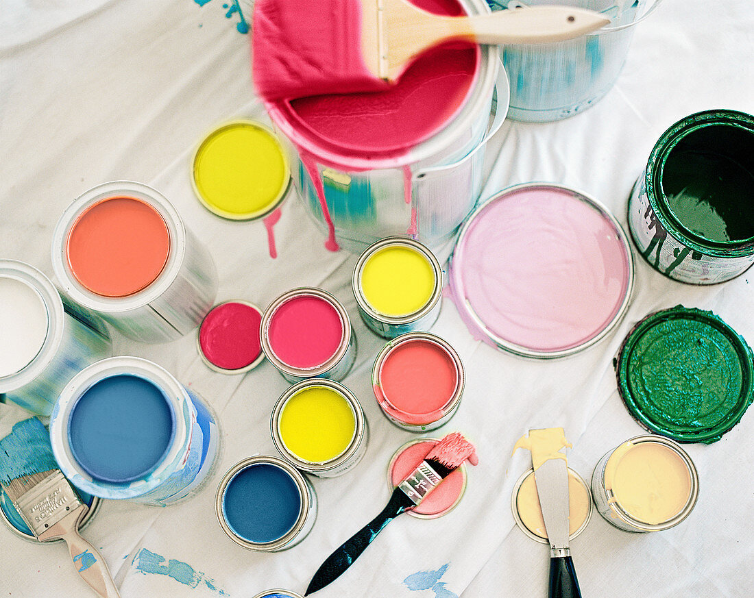 Opened paint pots with pastel colors