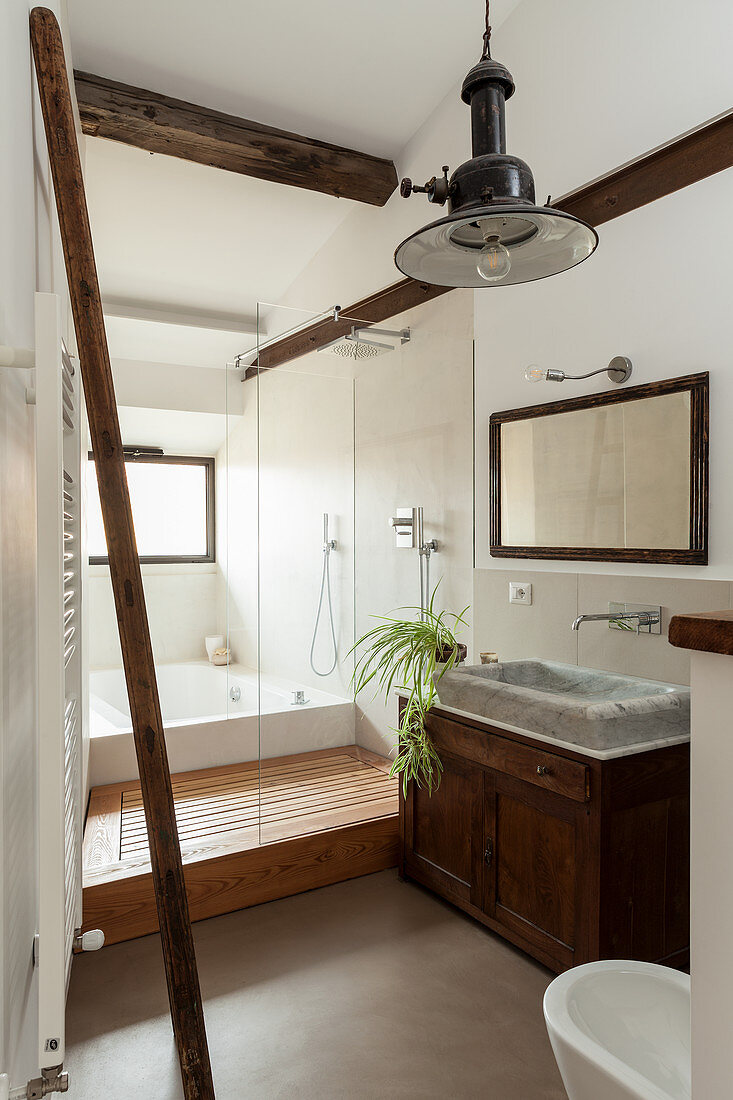Blick ins Badezimmer mit rustikalem Waschtischmöbel und Marmor-Waschbecken