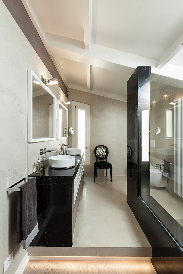Elegant bathroom in black and beige with sloping ceiling